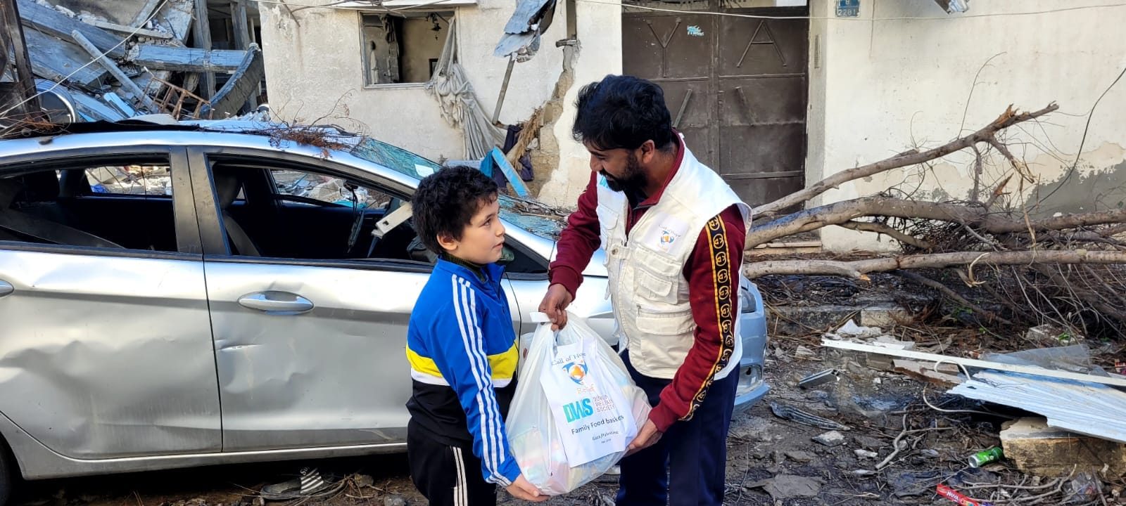 A Call of Hope volunteer handing a bag of supplies to a boy